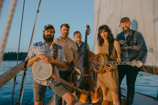 Five Band Members Posing on a Boat