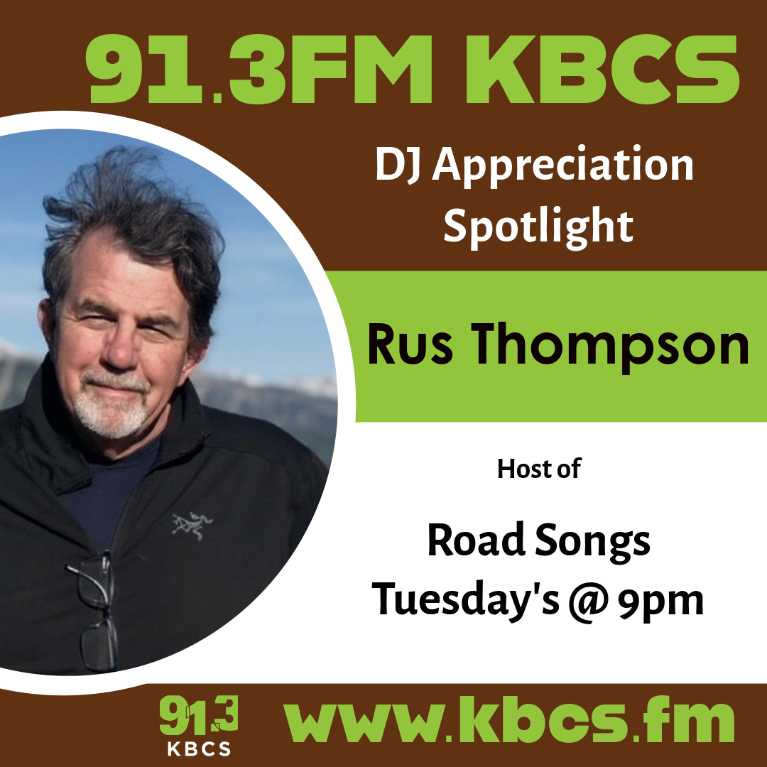 A poster for a DJ appreciation post from KBCS. This post features Rus Thompson, a white man with medium length grey hair, a short grey beard, and a black zip up jacket. He is outside with the sky behind him.