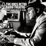 Black and white image of man at controls in suit and hat