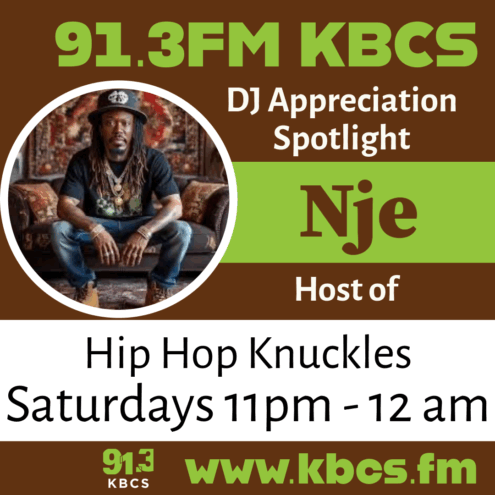 Nje sitting on couch in back shirt and jeans - KBCS DJ logo brown and green with text