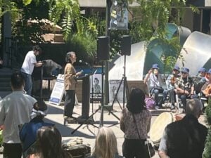 Speaker at podium outside Bellevue College quad